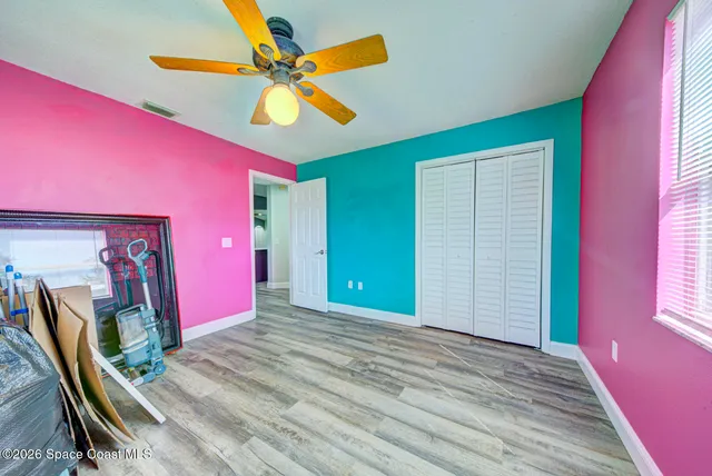 a view of a livingroom with furniture a floor to ceiling window and a flat screen tv