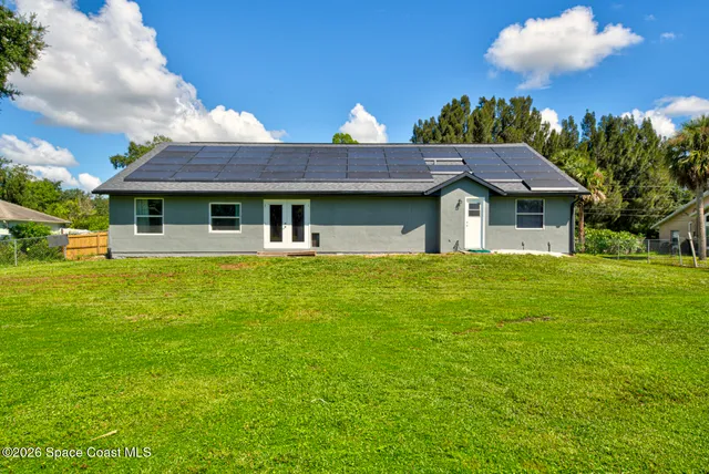 a house view with swimming pool in front of it