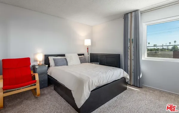 a bedroom with bed and window