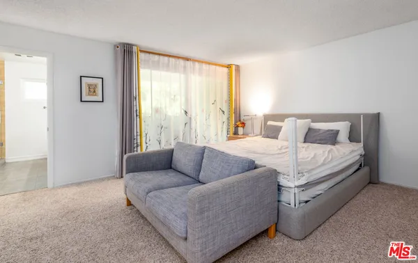 a bedroom with furniture and a couch