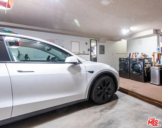 a utility room with lots of parked cars and other equipment