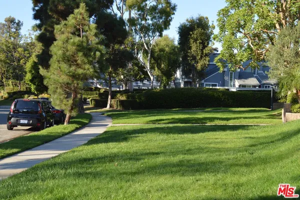a view of yard with swimming pool and green space