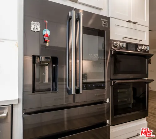a kitchen with a refrigerator and a stove