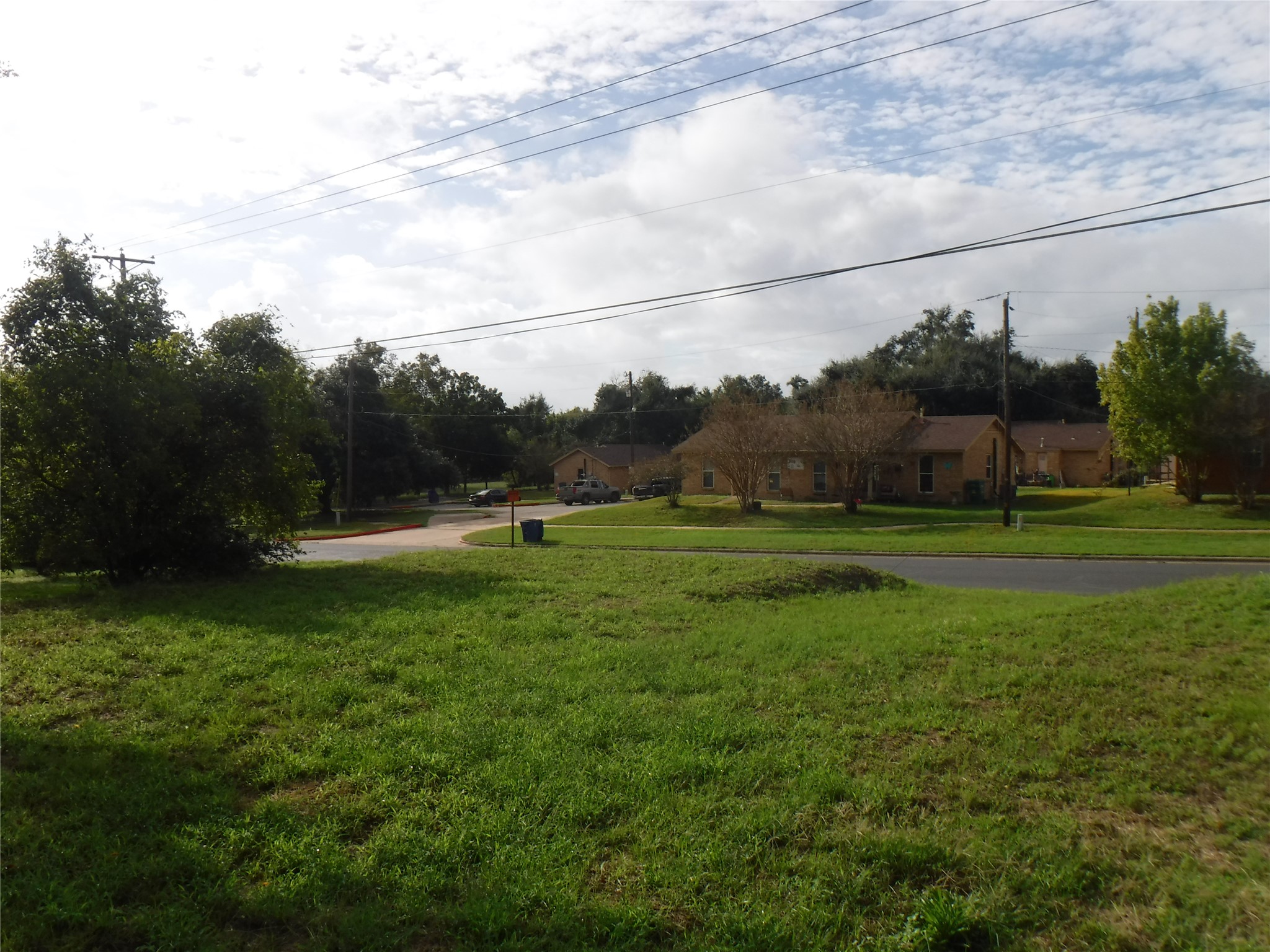 524 Old McDade Road Elgin, TX 78621 - Photo 6 of 9 Residential streetscape featuring a paved roadway and grassy areas