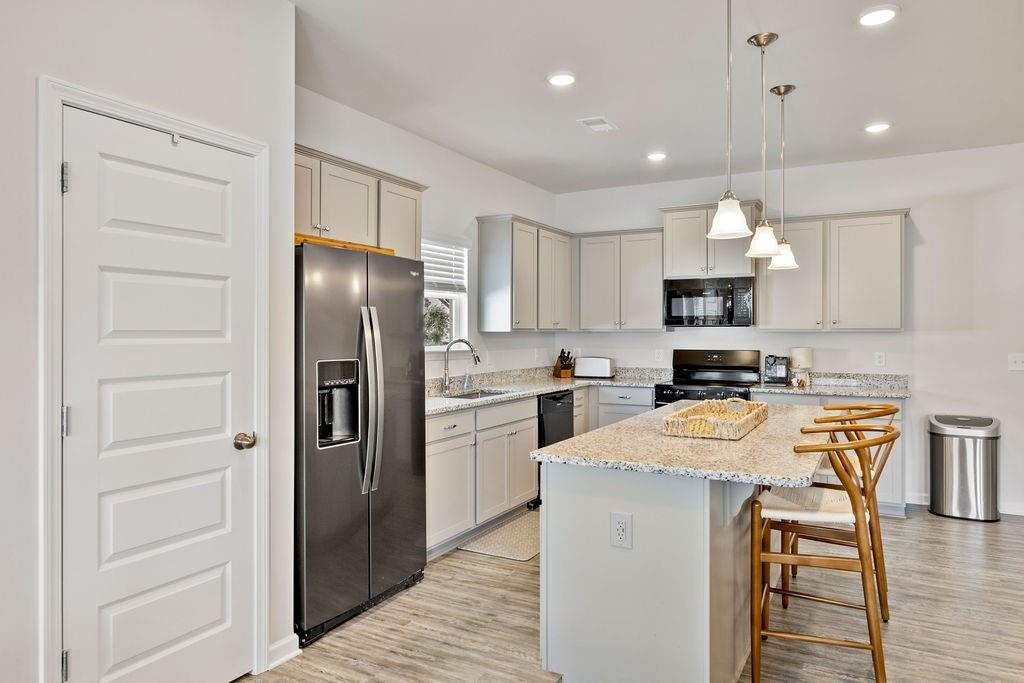 9 Mossy Oaks Lane Northeast Rome, GA 30165 - Photo 11 of 32 a kitchen with white cabinets and stainless steel appliances
