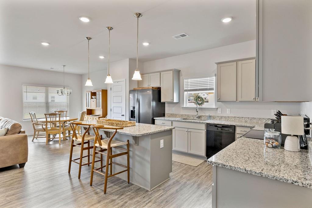 9 Mossy Oaks Lane Northeast Rome, GA 30165 - Photo 13 of 32 a kitchen with stainless steel appliances granite countertop wooden floor sink stove dining table and chairs