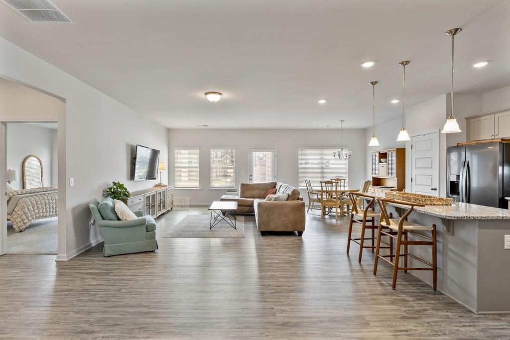 9 Mossy Oaks Lane Northeast Rome, GA 30165 - Photo 14 of 32 a living room with furniture kitchen area and a wooden floor