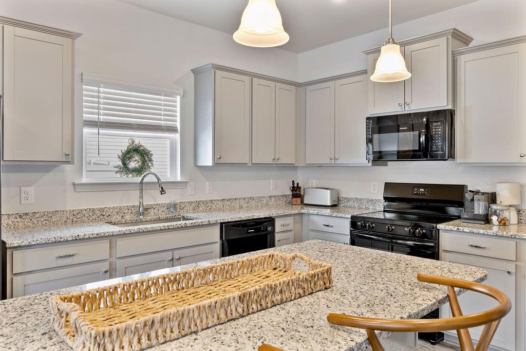 9 Mossy Oaks Lane Northeast Rome, GA 30165 - Photo 15 of 32 a kitchen with a stove a sink and a microwave
