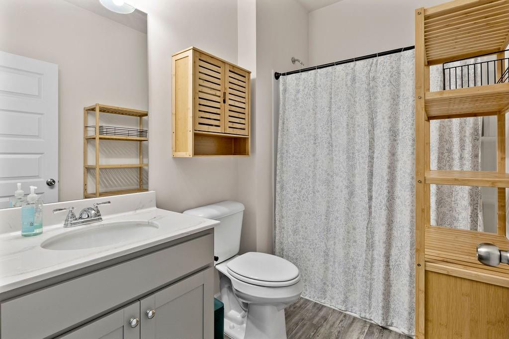 9 Mossy Oaks Lane Northeast Rome, GA 30165 - Photo 19 of 32 a bathroom with a sink a toilet and a mirror