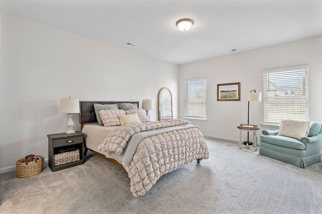 9 Mossy Oaks Lane Northeast Rome, GA 30165 - Photo 27 of 32 a bedroom with a bed a couch and a window