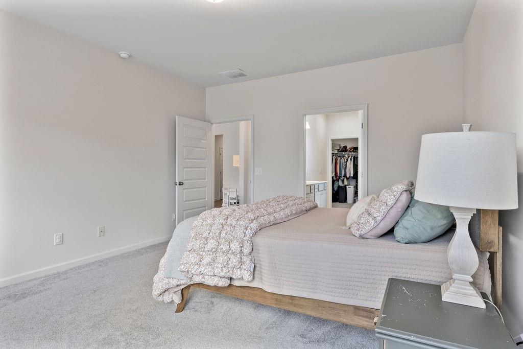 9 Mossy Oaks Lane Northeast Rome, GA 30165 - Photo 29 of 32 a bedroom with a bed and a lamp
