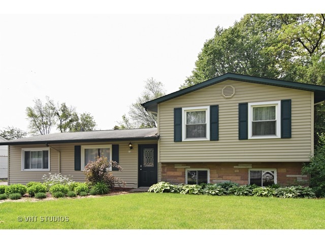 515 Redwood Road Bolingbrook, IL 60440 - Photo 1 of 15 a front view of a house with a yard