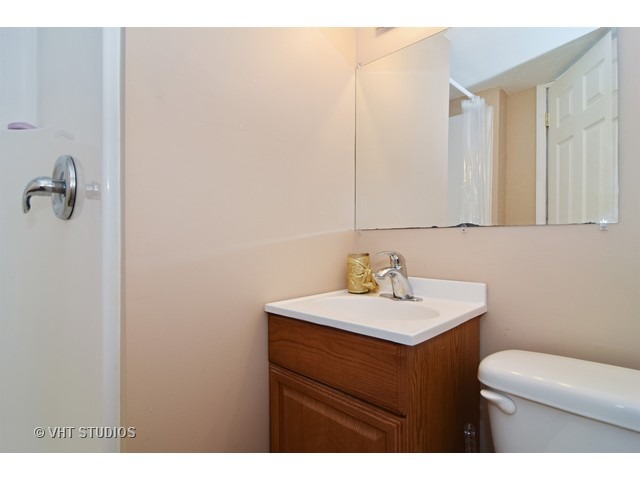 515 Redwood Road Bolingbrook, IL 60440 - Photo 13 of 15 a bathroom with a sink vanity mirror and toilet