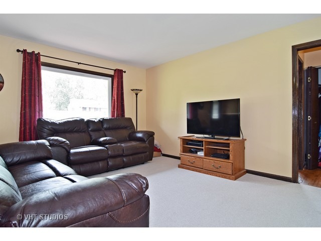 515 Redwood Road Bolingbrook, IL 60440 - Photo 3 of 15 a living room with furniture and a flat screen tv