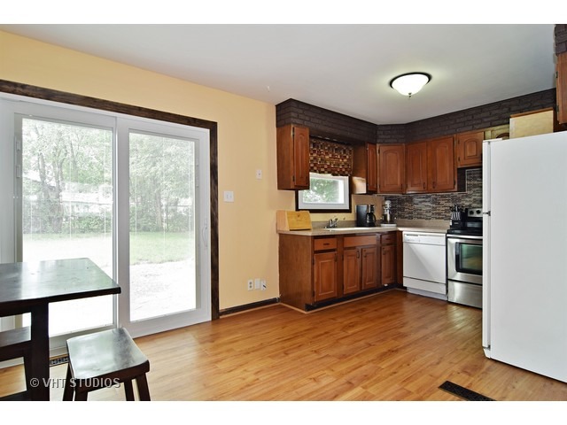 515 Redwood Road Bolingbrook, IL 60440 - Photo 5 of 15 a kitchen with a stove a sink and a refrigerator
