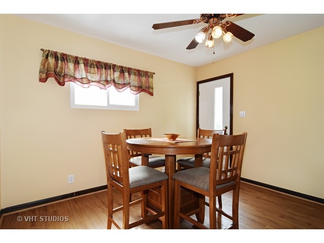515 Redwood Road Bolingbrook, IL 60440 - Photo 7 of 15 a view of a dining room with furniture and wooden floor