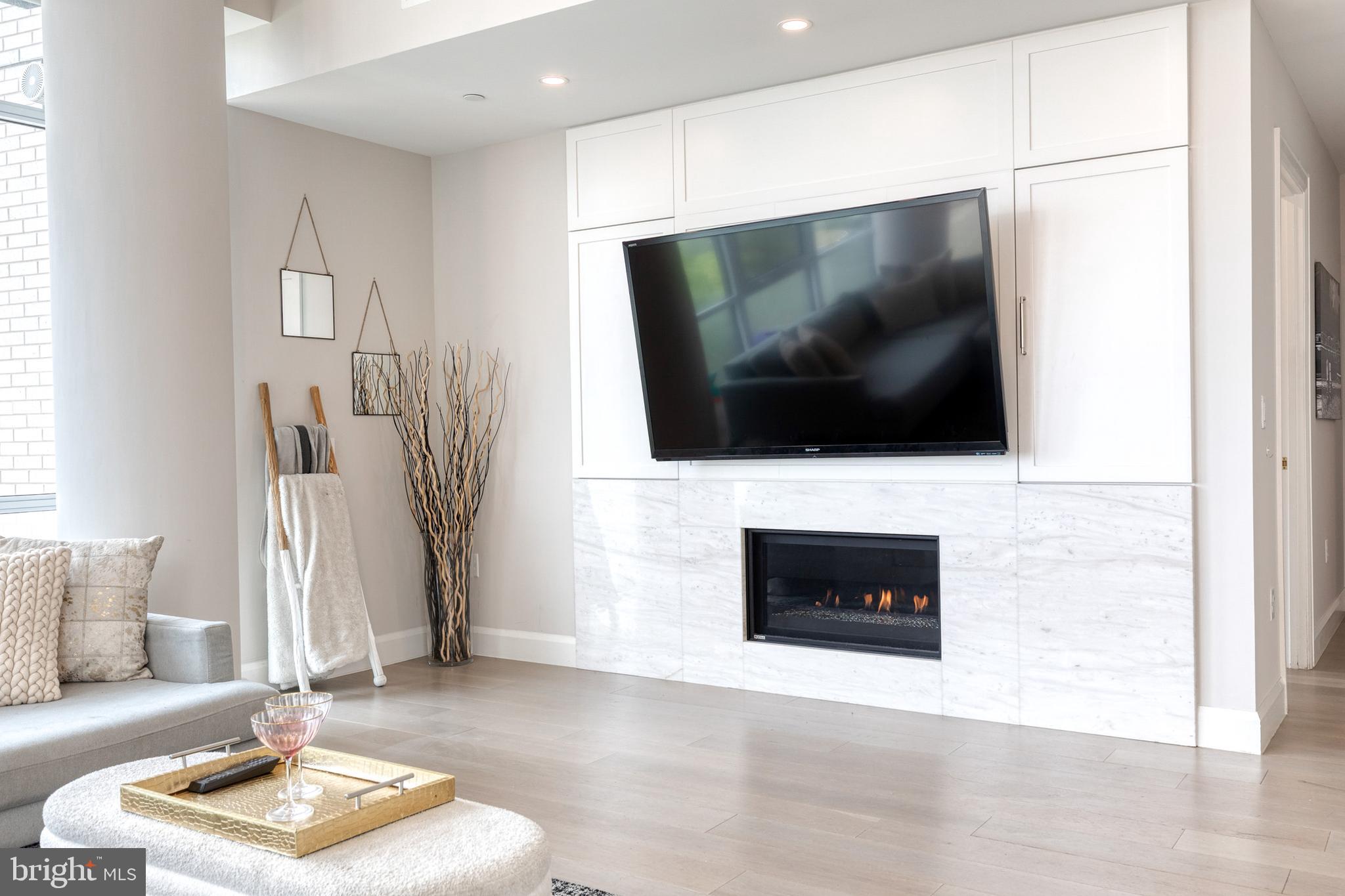 1330 Lancaster Street, Unit C701 Baltimore, MD 21231 - Photo 14 of 73 a living room with furniture and a flat screen tv