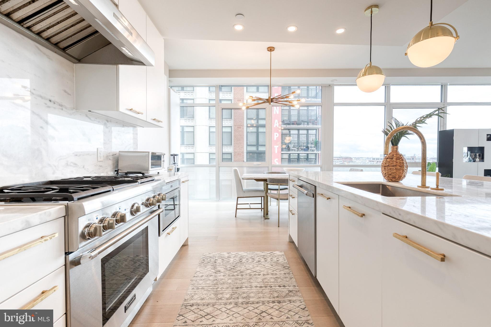 1330 Lancaster Street, Unit C701 Baltimore, MD 21231 - Photo 18 of 73 a large kitchen with stainless steel appliances granite countertop a stove a sink and a large refrigerator