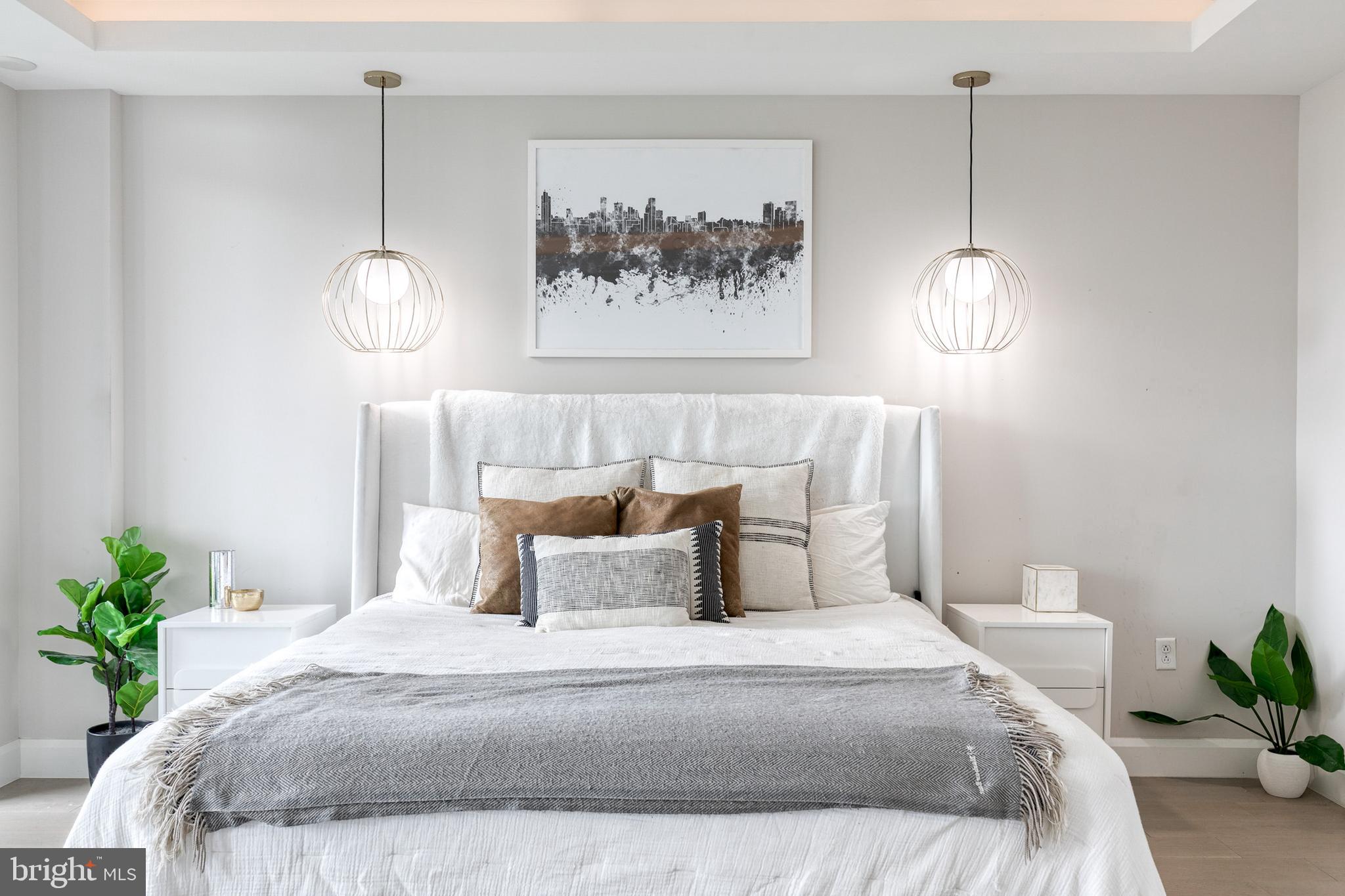 1330 Lancaster Street, Unit C701 Baltimore, MD 21231 - Photo 35 of 73 a bedroom with bed and a potted plant