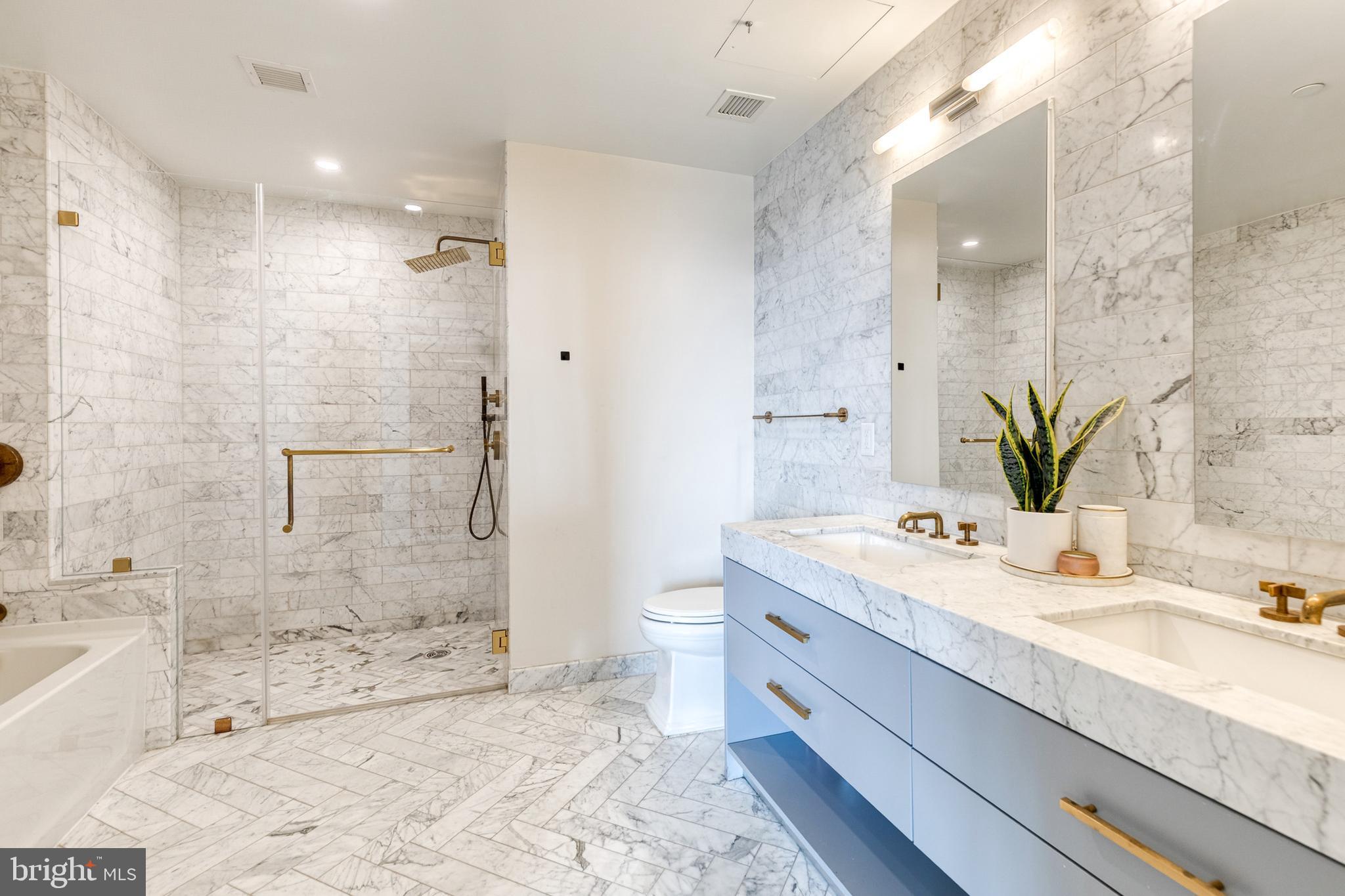 1330 Lancaster Street, Unit C701 Baltimore, MD 21231 - Photo 42 of 73 a bathroom with a granite countertop sink mirror and a bathtub