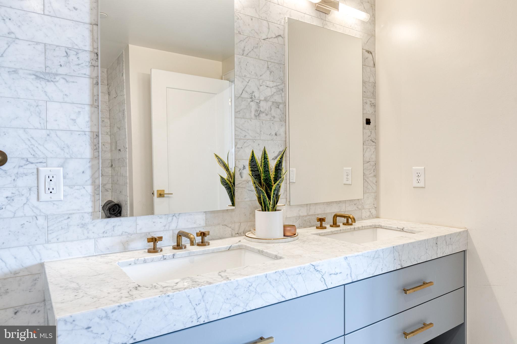 1330 Lancaster Street, Unit C701 Baltimore, MD 21231 - Photo 45 of 73 a bathroom with a granite countertop sink and a mirror