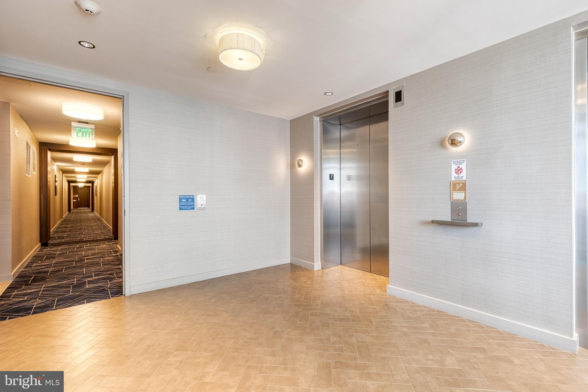 1330 Lancaster Street, Unit C701 Baltimore, MD 21231 - Photo 49 of 73 a view of a hallway with wooden shelves