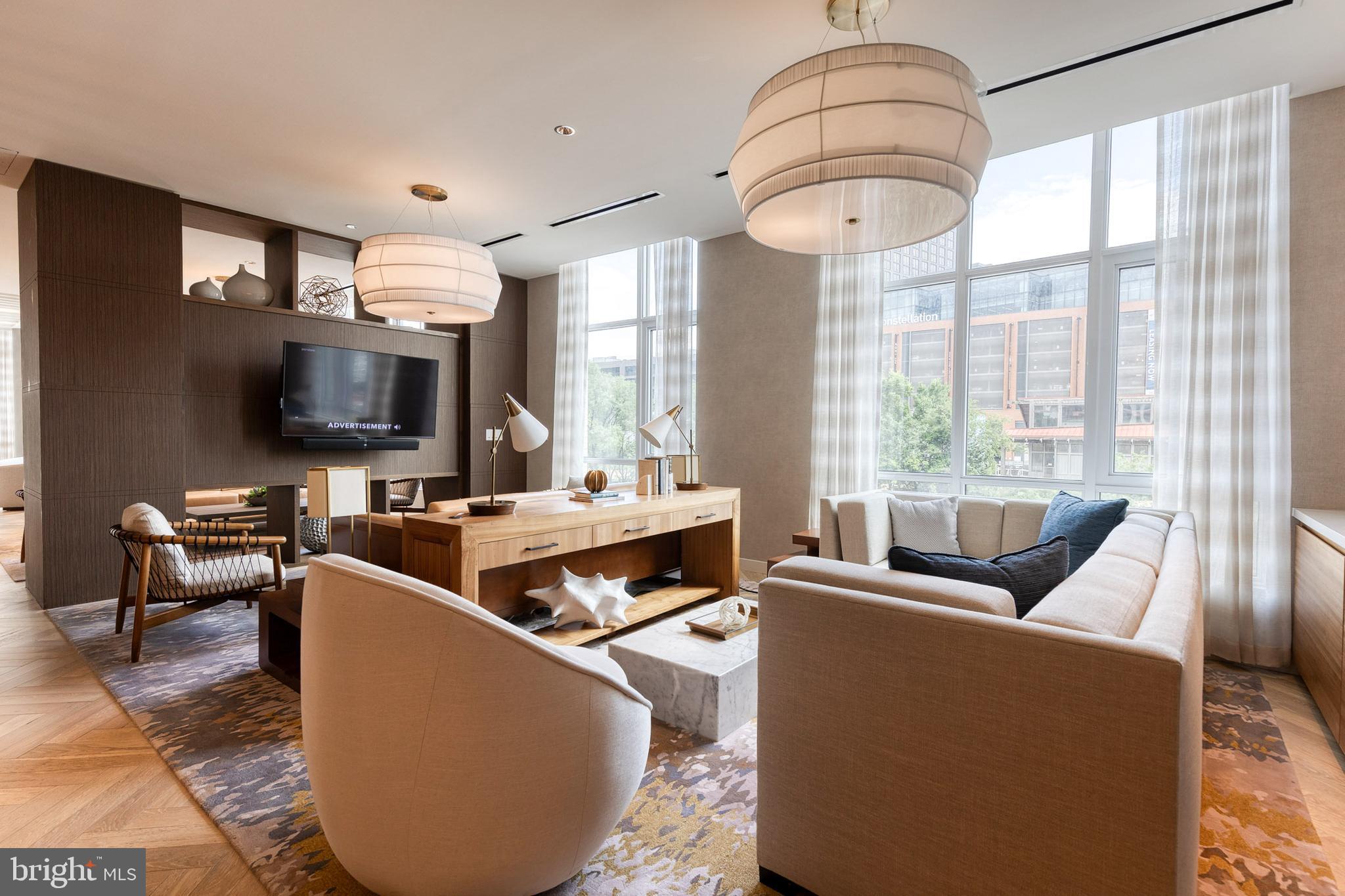 1330 Lancaster Street, Unit C701 Baltimore, MD 21231 - Photo 57 of 73 a living room with furniture a flat screen tv and a large window