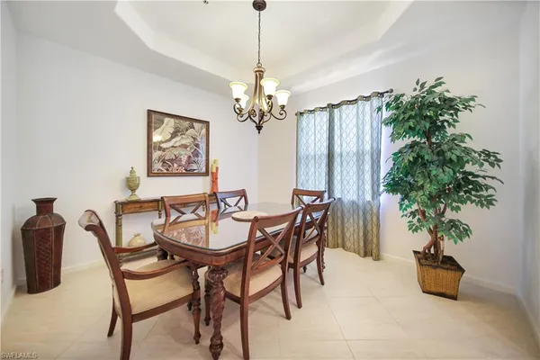 a view of a dining room with furniture and a chandelier