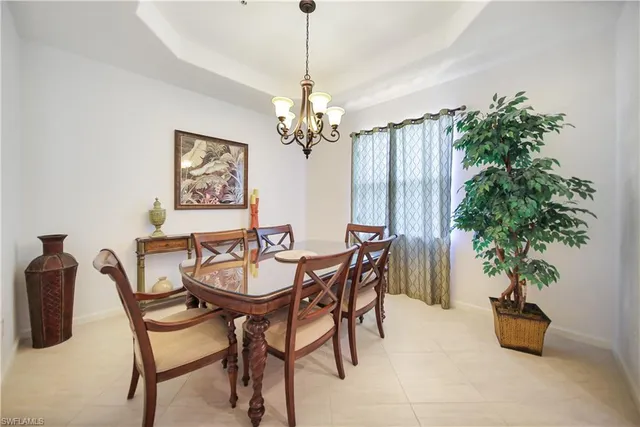 a view of a dining room with furniture and a chandelier