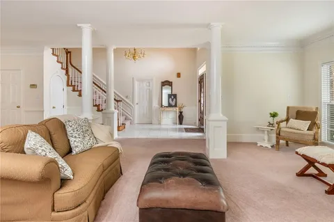 a living room with furniture and a chandelier