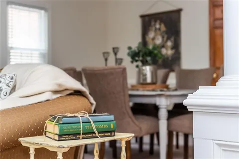 a kitchen with table chairs sink refrigerator and cabinets