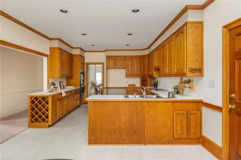 a spacious bedroom with a bed and a chandelier