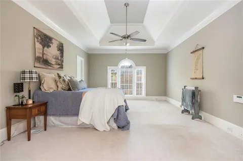 an empty room with closet and chandelier fan