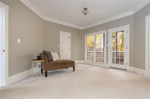 an empty room with a ceiling fan and carpet