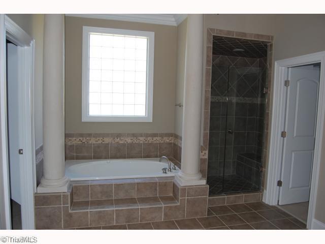 8405 Oakchester Court Oak Ridge, NC 27310 - Photo 5 of 6 Master Bath/Spa. Bath with jetted tub and separate shower. Exquisite tile work and detail.