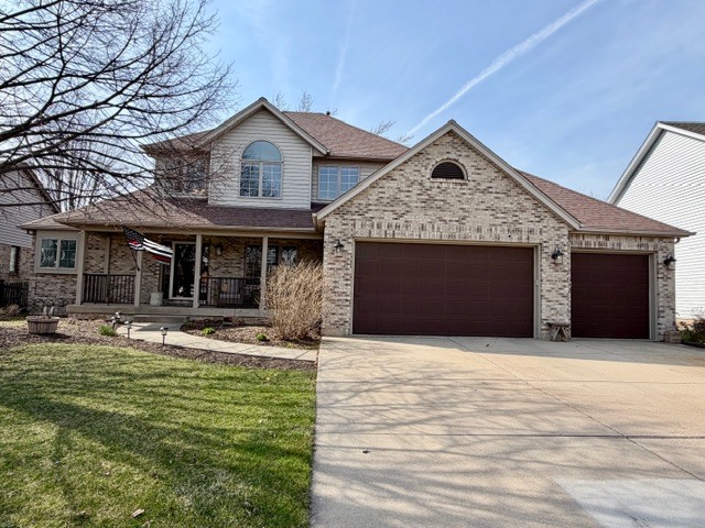 1325 Foxpointe Drive Sycamore, IL 60178 - Photo 1 of 55 a front view of a house with garden