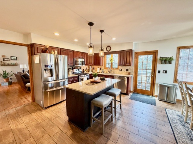 1325 Foxpointe Drive Sycamore, IL 60178 - Photo 13 of 55 a kitchen with stainless steel appliances granite countertop a table chairs and a refrigerator