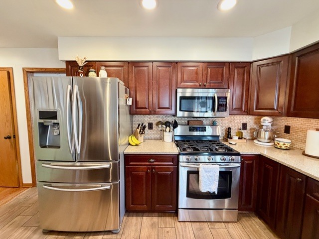 1325 Foxpointe Drive Sycamore, IL 60178 - Photo 15 of 55 a kitchen with granite countertop a refrigerator stove and microwave