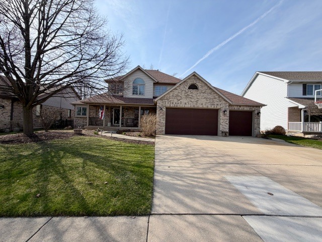 1325 Foxpointe Drive Sycamore, IL 60178 - Photo 2 of 55 a front view of a house with a garden and trees
