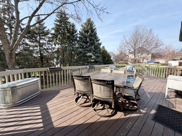 1325 Foxpointe Drive Sycamore, IL 60178 - Photo 52 of 55 a view of a roof deck with table and chairs floor to ceiling window with wooden floor