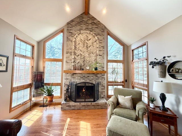 1325 Foxpointe Drive Sycamore, IL 60178 - Photo 9 of 55 a living room with furniture a fireplace and a floor to ceiling window
