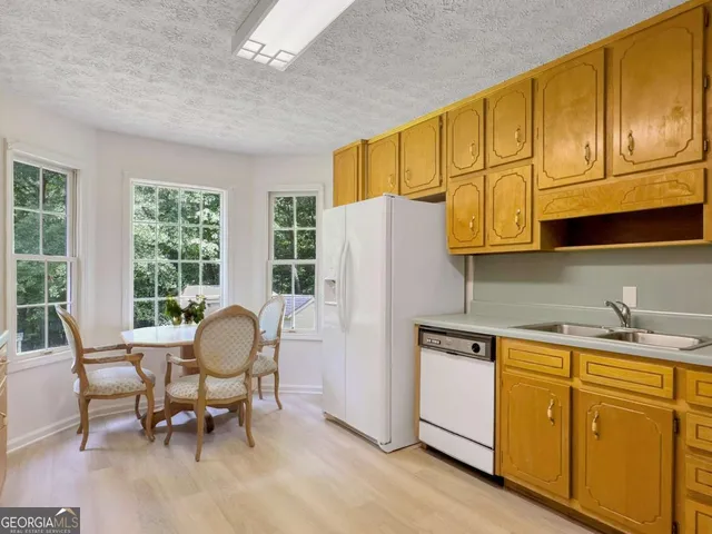 a dining room with furniture a chandelier and wooden floor