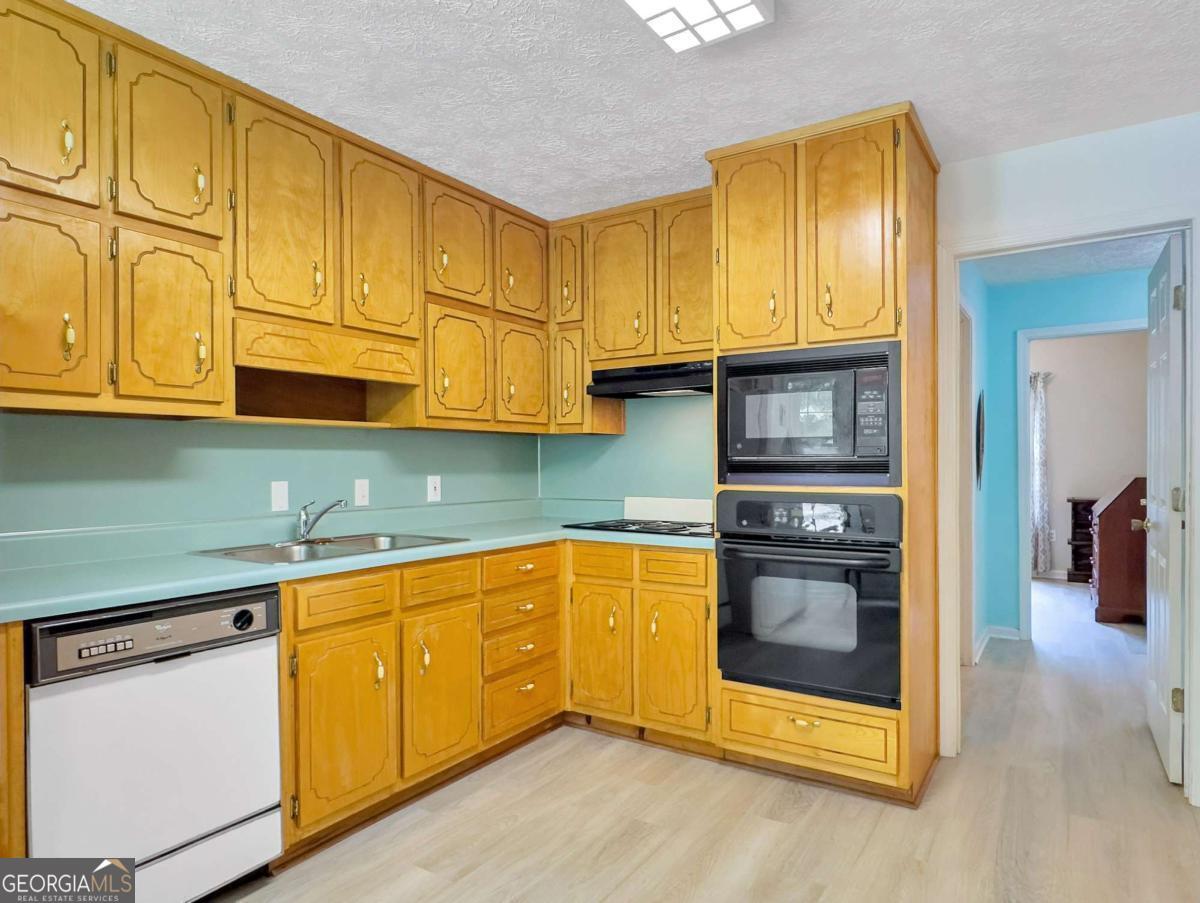 240 Riverview Road Jackson, GA 30233 - Photo 21 of 79 a kitchen with stainless steel appliances granite countertop a stove a sink and a microwave