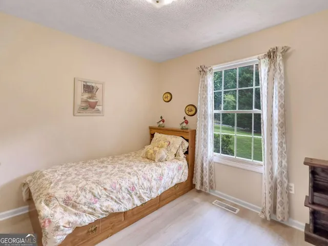 a spacious bedroom with a bed and a table