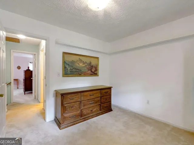 a bed room with a bed and a lamp on table