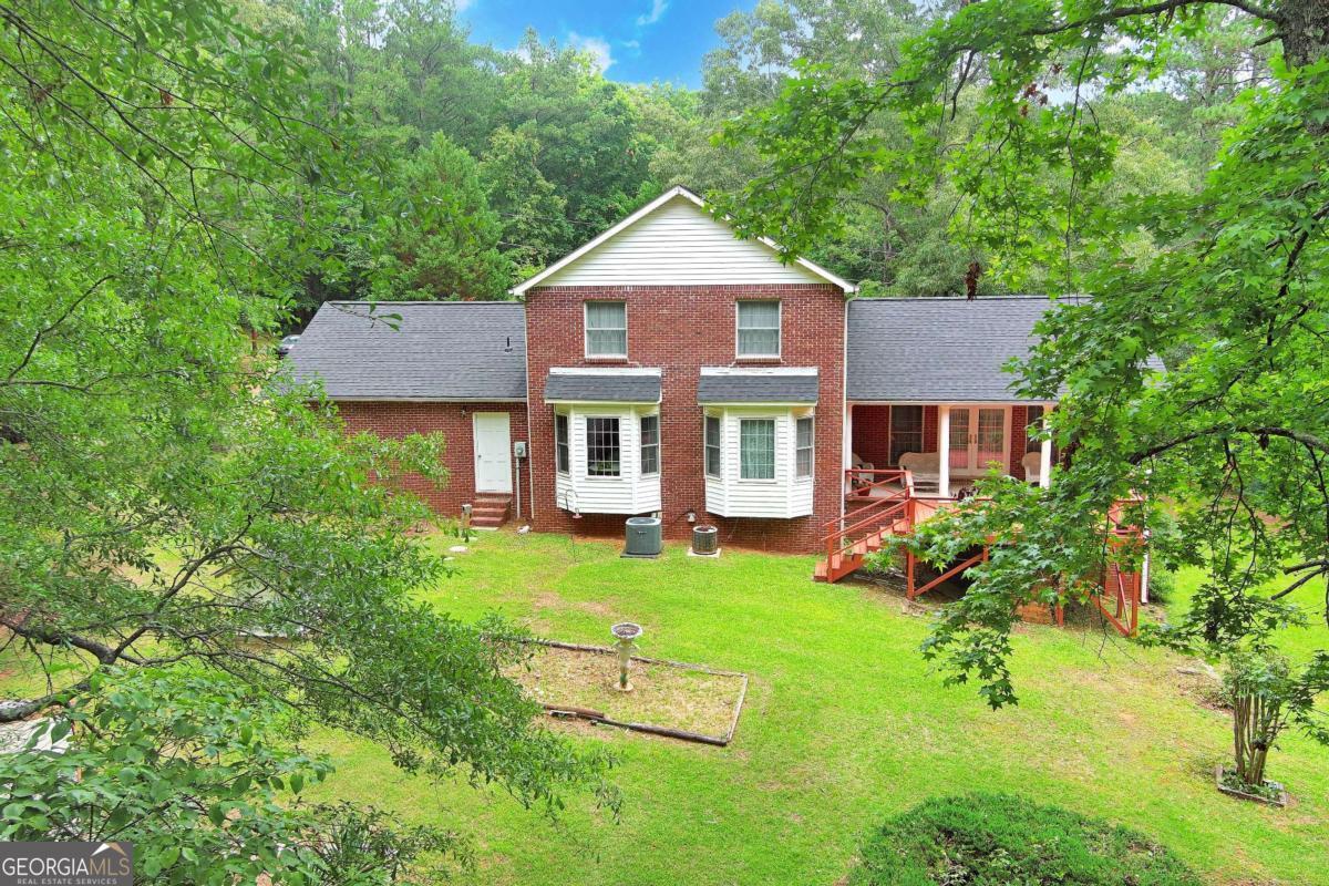 240 Riverview Road Jackson, GA 30233 - Photo 72 of 79 a view of a yard in front of a house with large windows
