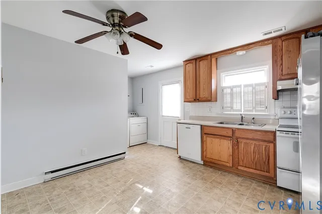 a kitchen with a refrigerator a sink and cabinets