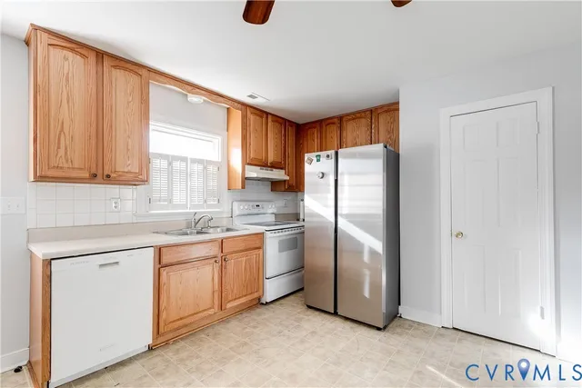 a kitchen with stainless steel appliances a refrigerator sink and cabinets