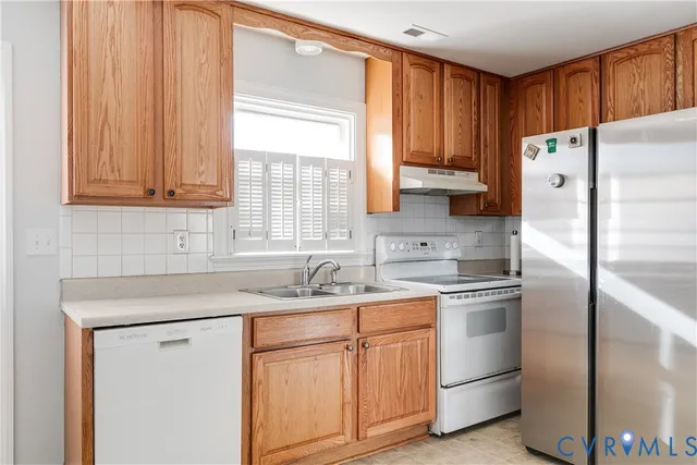 a kitchen with a sink cabinets and refrigerator