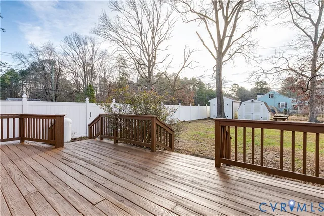 a view of a balcony with wooden floor and fence
